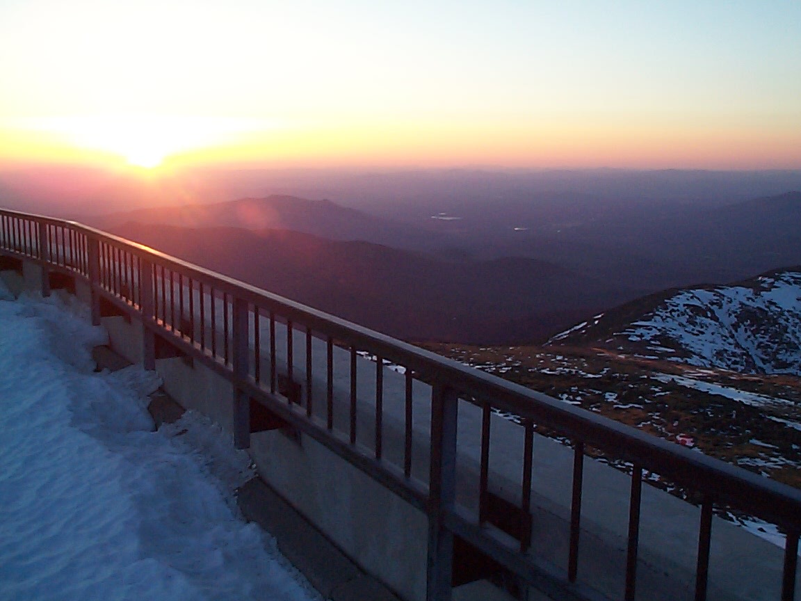 Sunrise from the observatory rail, with snow piled along the summit deck.